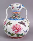 A CHINESE FAMILLE ROSE PORCELAIN TWIN HANDLE VASE, The body decorated with butterfly and flora,