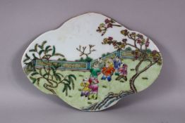 A CHINESE FAMILLE ROSE PORCELAIN BOYS TILE SECTION, of quatrelobe form, deppicting boys playing in a