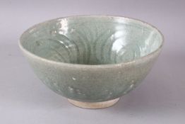 A GOOD THAI SUKHOTHAI CELADON POTTERY BOWL, with moulded interior decoration and a short falling