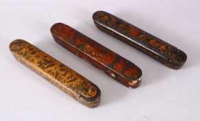 THREE 19TH CENTURY PERSIAN QAJAR LACQUER PEN BOXES, 23cm long.