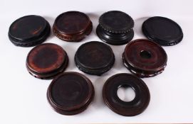 A MIXED LOT OF 12 CHINESE CARVED HARDWOOD STANDS - each of varying size, style and timber, the