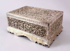 A 19TH CENTURY INDIAN OPENWORK SILVER LIDDED BOX, decorated in open work depicting birds and