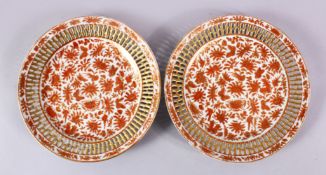 A FINE PAIR OF 19TH CENTURY CHINESE IRON RED & GILT RETICULATED PLATES, each plate with iron red
