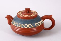 A CHINESE YIXING CLAY TEAPOT, with moulded and poly chrome decoration, lid and base with impressed