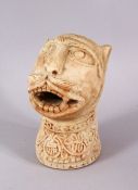 AN EARLY ISLAMIC CARVED MARBLE LIONS HEAD FIGURE, the lion bearing its teeth looking aloft, with