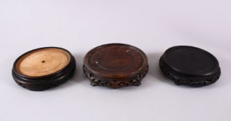 A MIXED LOT OF THREE CHINESE CARVED HARDWOOD STANDS, largest housing a vase no greater than 15cm.