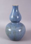 A CHINESE MONOCHROME PALE BLUE GLAZED PORCELAIN GOURD VASE, 20cm high.