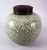 A 19TH / 20TH CENTURY CHINESE CELADON GLAZED PORCELAIN GINGER JAR & HARDWOOD COVER, the body of