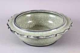 A CHINESE BARBED RIM GUAN GLAZED POTTERY DISH, the flared rim with ironwire style body decoration,