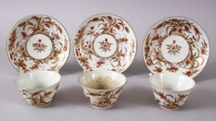 THREE JAPANESE MEIJI PERIOD ARITA PORCELAIN CUP & SAUCERS, with filt and orange floral decoration,