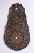 A CHINESE CARVED JADE BI DISK, carved with archaic style bats and chilong, 29cm x 16.5cm