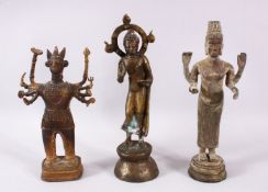 THREE EARLY/MID-20TH CENTURY ORIENTAL BRONZE FIGURES, 25cm, 24cm and 21cm high.
