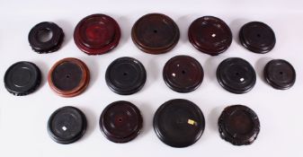 A MIXED LOT OF 15 CHINESE CARVED HARDWOOD STANDS - each of varying size, style and timber, the