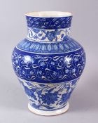 A LARGE 18TH CENTURY IZNIK BLUE & WHITE POTTERY VASE, decorated with flora and floral motif