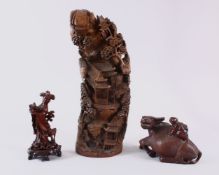 A LARGE CARVED AND PIERCED BAMBOO GROUP, 45cm high, a carved wood oxen, 19cm, and female figure on