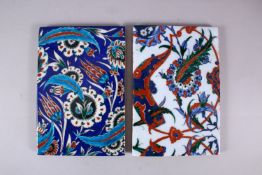 TWO GOOD IZNIK STYLE POTTERY TILE SECTIONS, one with a blue ground and feather and floral