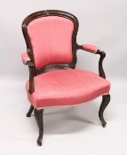 A GEORGE III SHAPED BACK ARM CHAIR with padded back, arms and seat on turned fluted legs.