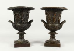 A GOOD PAIR OF CLASSICAL TWO HANDLED CAMPAGNAS URNS on square bases. 12ins high