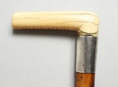 A VICTORIAN BONE HANDLED WALKING STICK, with silver band. 32ins long