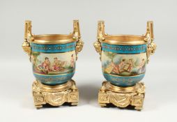 A GOOD PAIR OF SEVRES PORCELAIN AND ORMOLU TWO HANDLED CACHE POTS. 13ins high.