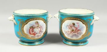 A LARGE PAIR OF SEVRES CIRCULAR BLUE GROUND COOLERS edged in gilt and painted with reverse panels of