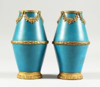 A SMALL PAIR OF SEVRES BLUE GROUND VASES with gilt garlands Mark in blue S 5 ins high