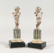 A SUPERB SMALL PAIR OF SILVERED BRONZE AND ENAMEL CUPIDS ON STANDS 6Ins high