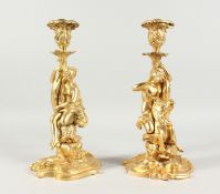 A VERY GOOD PAIR OF GILT BRONZE CLASSICAL FIGURAL CANDLESTICKS. 12ins high.