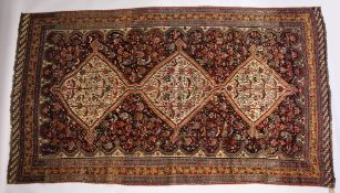 A GOOD LARGE EARLY 20TH CENTURY QASHQAI CARPET with three central diamond shaped, decorated all over