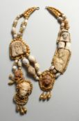 A ROAMN STONE HEAD AND PEBBLE AND SILVER NECKLACE