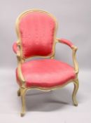 A GEORGE III ARM CHAIR, with padded back, arms and seat on cabriole legs.