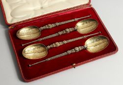 A SET OF FOUR EDWARD VII SILVER GILT APOSTLE SPOONS 10ins long London 1902, maker, Goldsmith and
