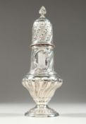 A VICTORIAN SUGAR SIFTER with repousse decoration. 9ins high London 1900