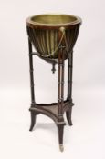 A MAHOGANY JARDINIERE with brass bowl and double column support with under tier 2ft 9ins high.