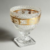 A LARGE CUT GLASS AND GILT FRUIT BOWL on a square base. Possibly MOSER. 8ins high.
