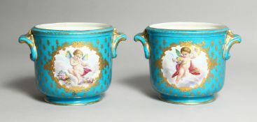 A GOOD PAIR OF SEVRES BLUE GROUND COOLERS edged in gilt and painted with reverse pairs of cupids