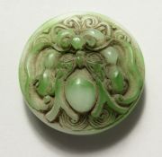 A CHINESE CIRCULAR CARVE JADE BELT BUCKLE. 2.25ins diameter.