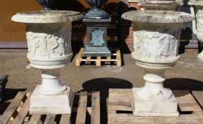 A SUPERB NEAR PAIR OF ITALIAN CARVED WHITE MARBLE URNS ON STANDS, the sides covered with dancing