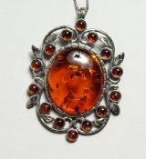 A SILVER AND AMBER PEDANT ON ACHAIN