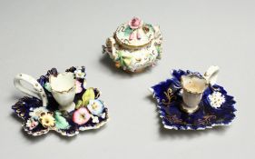 A SMALL COALPORT FLOWER ENCRUSTED TWO HANDLED BOWL AND COVER. 2.5ins high, mark in blue and two