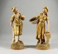 A PAIR OF ROYAL DUX FIGURES OF A MAN HOLDING A PIPE and a woman carrying two baskets. Triangular
