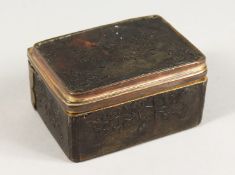 AN 18TH CENTURY TORTOISESHELL BOX AND COVER with musical trophies in relief. 3ins.