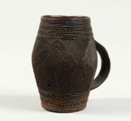 A CARVED WOOD CUP 3ins high.