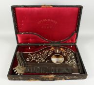 A. B. RACYNSKI SCHULZ'S ZITHER inlaid with coloured wood in an ANTON BRUER LINZ leather case.