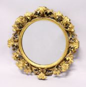A GOOD 19TH CENTURY FLORENTINE GILT FRAMED CIRCULAR MIRROR, with well carved leafwork frame. 1ft