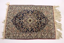 A GOOD, SMALL PERSIAN RUG, dark blue ground with stylised design 3ft 5ins x 2ft 6ins