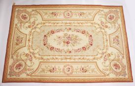 AN AUBUSSON STYLE TAPESTRY WALL HANGING, beige ground with floral decoration. 9ft x 6ft.