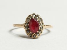 AN 18CT GOLD, RUBY AND DIAMOND CLUSTER RING