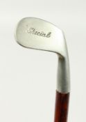 A SMALL WALKING STICK, the handle as a special metal golf club. 34ins long.