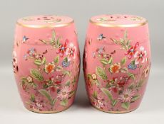A PAIR OF CHINESE PINK GARDEN SEATS decorated with butterflies and flowers 18ins high.
